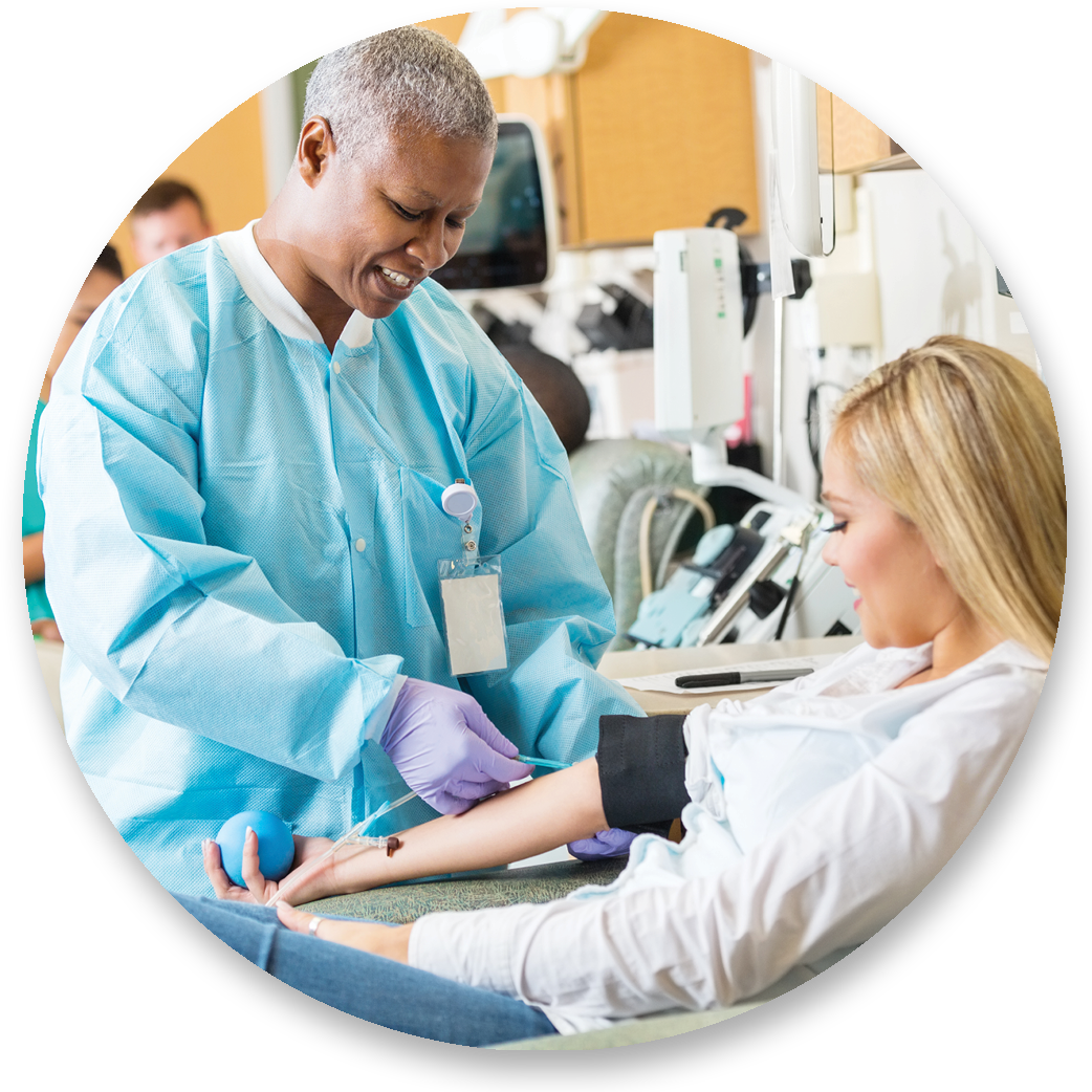 Phlebotomy Technician Draws blood from patient