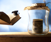 jar of cash and book. link to paying for college page