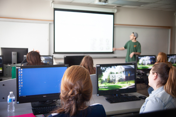 student giving presentation in computer classroom.