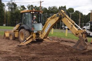 Kelly M. operating the backhoe