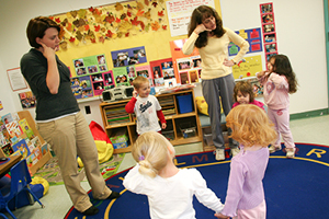teachers working with kids in preschool classroom