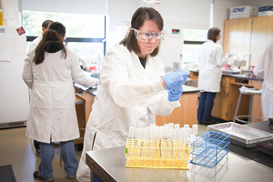 woman filling vials in lab