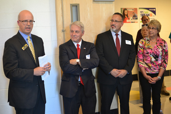Steve Minkler, Len Suzio, Miguel Cardona, and Adrienne Maslin standing and smiling during MxCC at Platt ribbon cutting