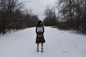 girl standing on snowy path